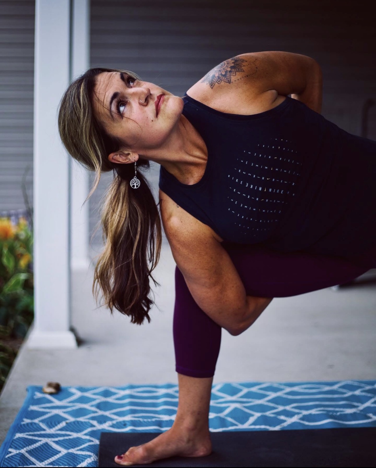 Crystal practicing yoga on a porch